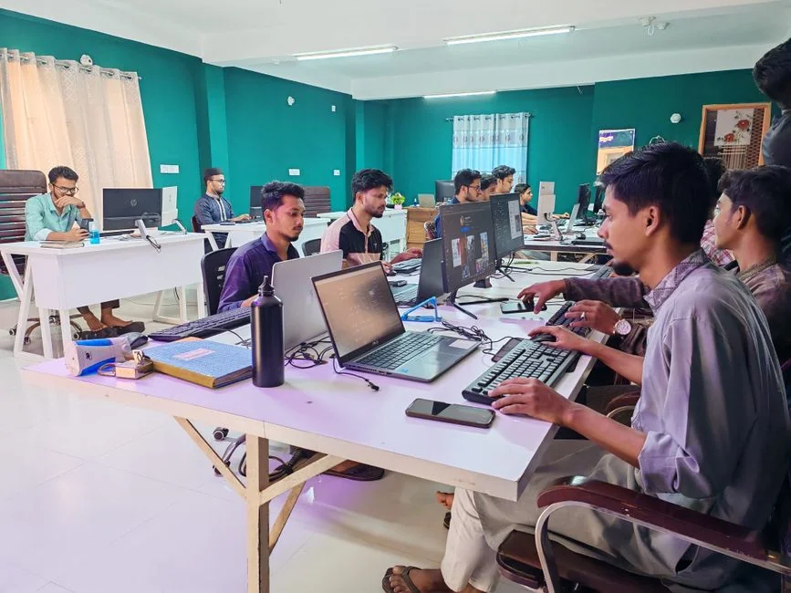 A modern workspace featuring dual computer monitors displaying web design projects, emphasizing technology and productivity.